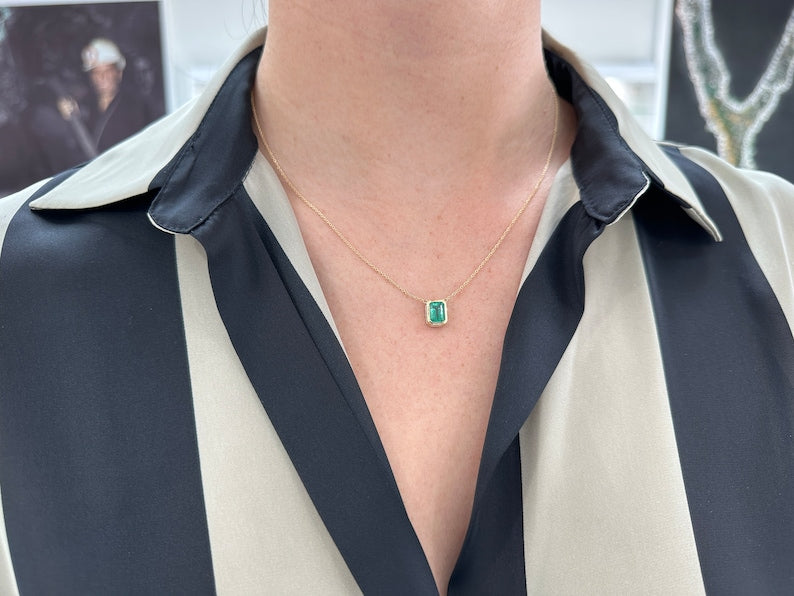 14K gold emerald cut emerald necklace with adjustable chain and bezel setting, featuring lush green Colombian emeralds.