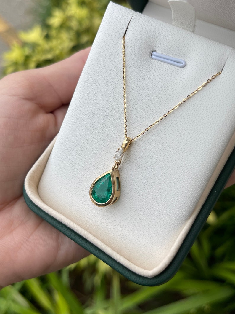Colombian Emerald teardrop pendant necklace with marquise diamond accents in 14K gold, natural pear-cut emerald, bezel setting.