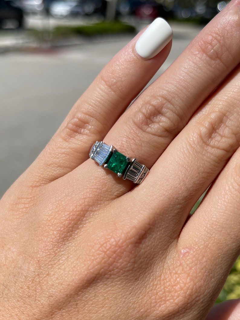 Dark green emerald engagement ring with Asscher cut and diamond accents in platinum, featuring AAA fine quality Colombian emerald.
