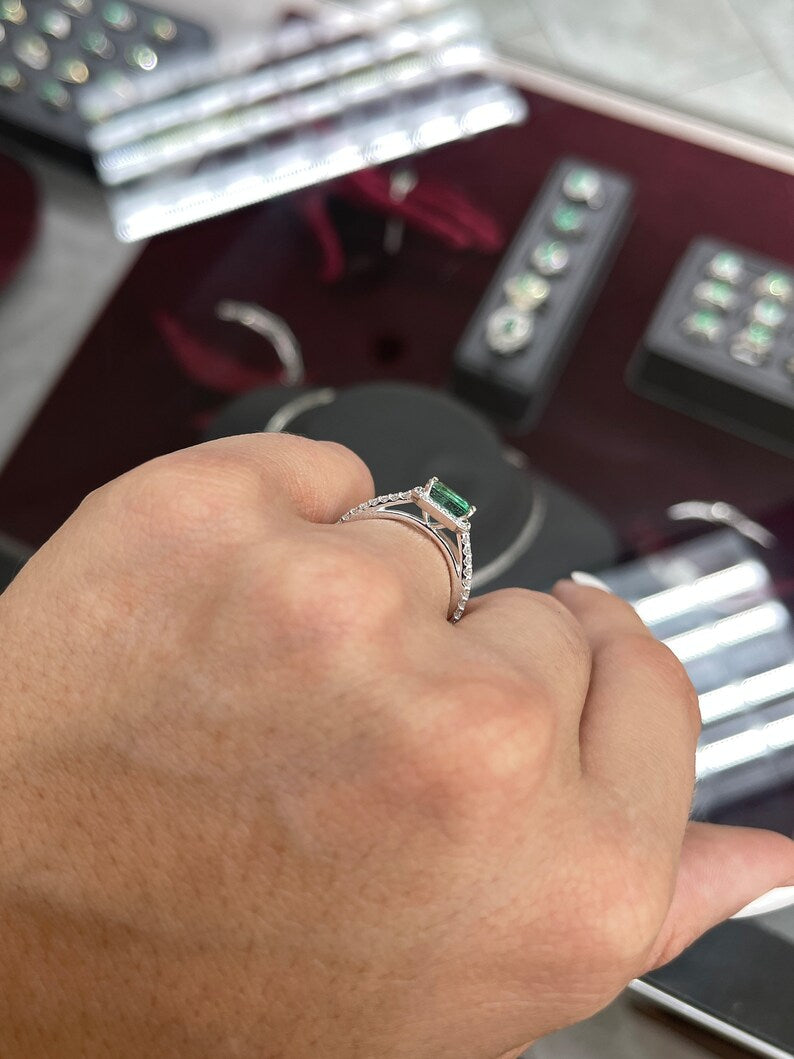 14K natural East to West emerald cut diamond halo engagement ring with Colombian Emerald branding, showcasing the elegant design.