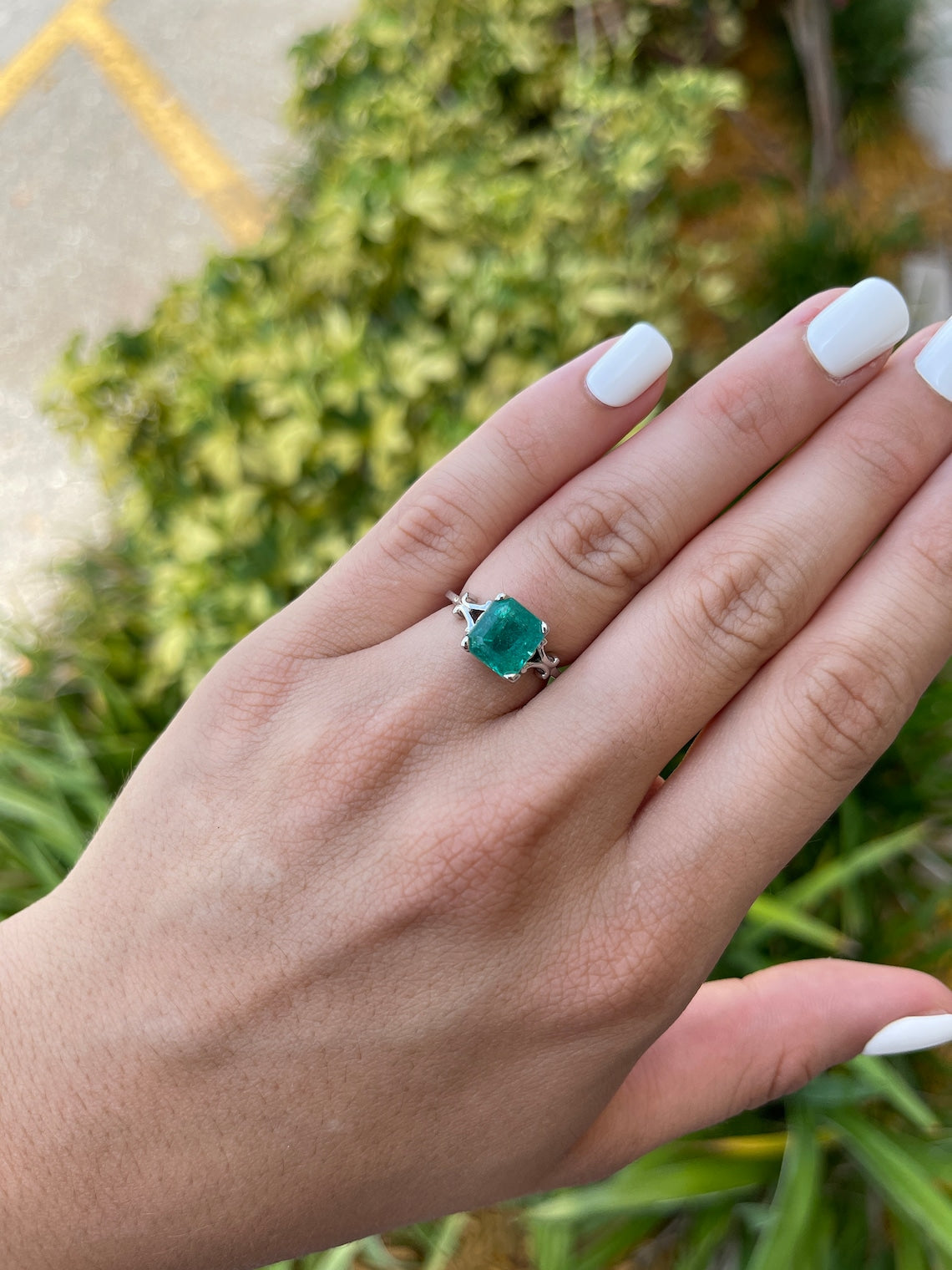 14K white gold engagement ring with a 3.25ct blue-green Asscher cut emerald and vintage scroll detailing by Colombian Emerald