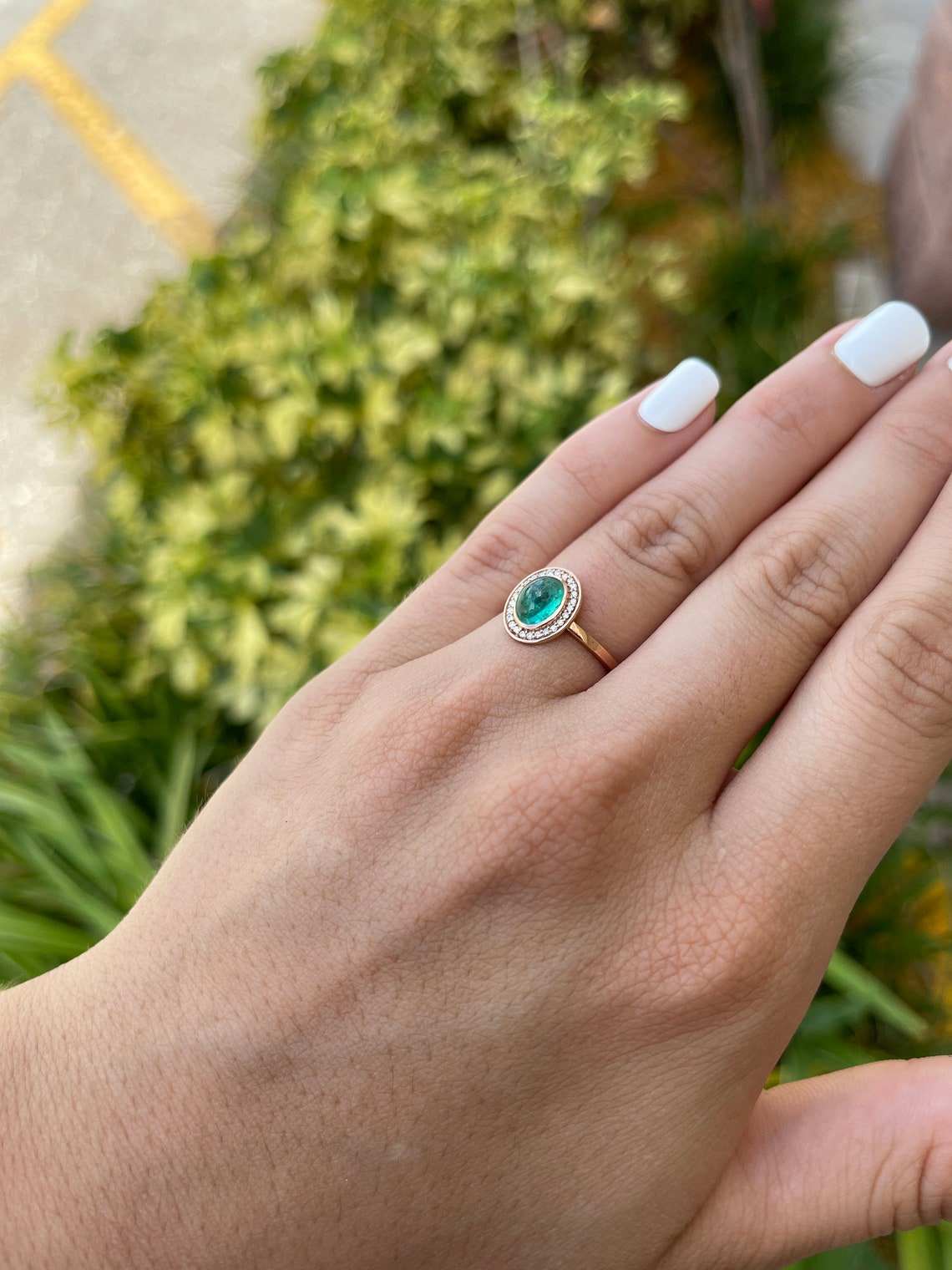 Colombian emerald oval cabochon ring with diamond pave halo, contemporary style, women's emerald statement jewelry.
