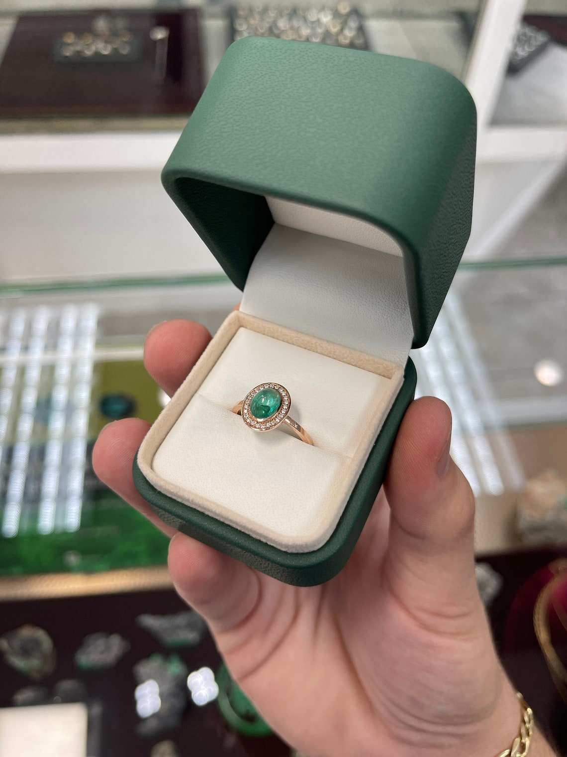 Colombian emerald oval cabochon ring with diamond pave halo and contemporary design for ladies jewelry.