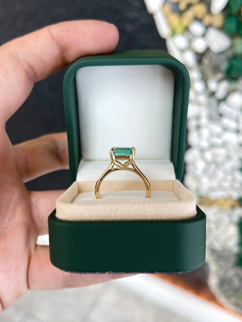 14K gold east-to-west emerald solitaire ring for women, featuring a 2.10 carat Colombian emerald on a simple, elegant band.