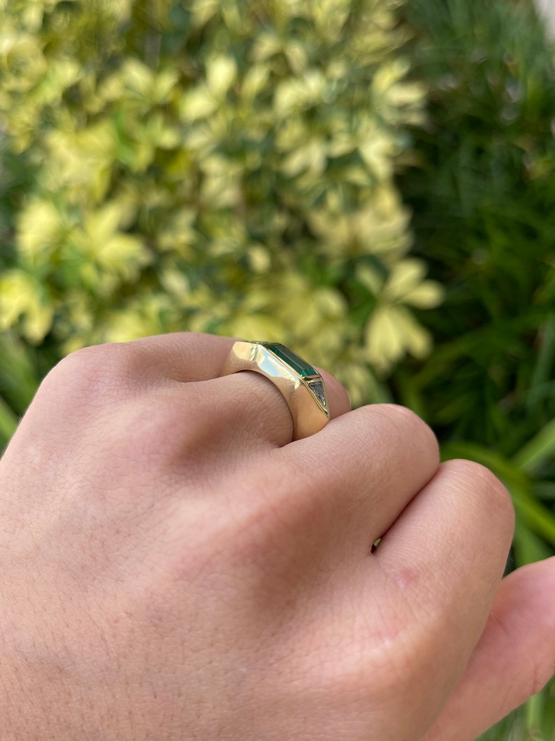Ladies emerald ring featuring 2.35tcw three-stone design with baguette, trillion cut diamonds, in 18K gold by Colombian Emerald.