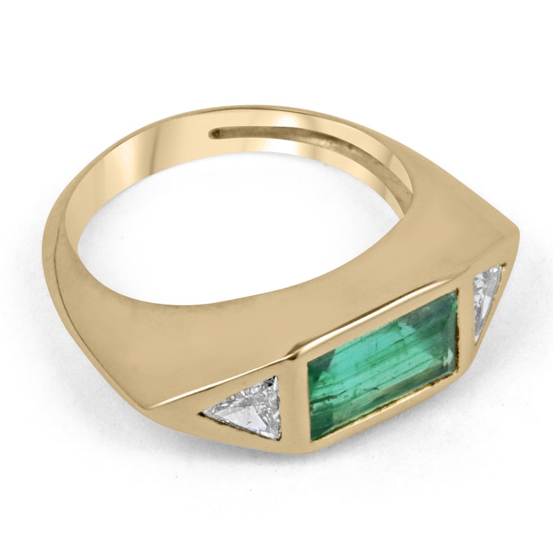 Ladies emerald ring featuring 2.35tcw AAA quality three stone baguette and trillion cut diamonds in a Colombian emerald design.