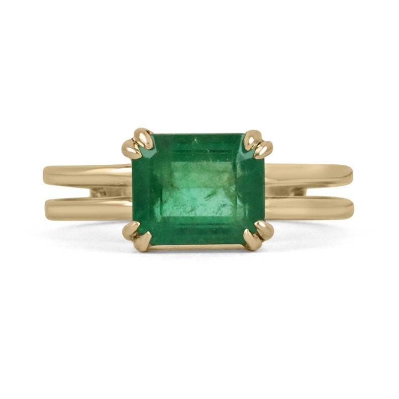 Colombian Emerald ladies ring with 2.68ct emerald cut yellowish-green gemstone, gold split shank, double claw prong setting.