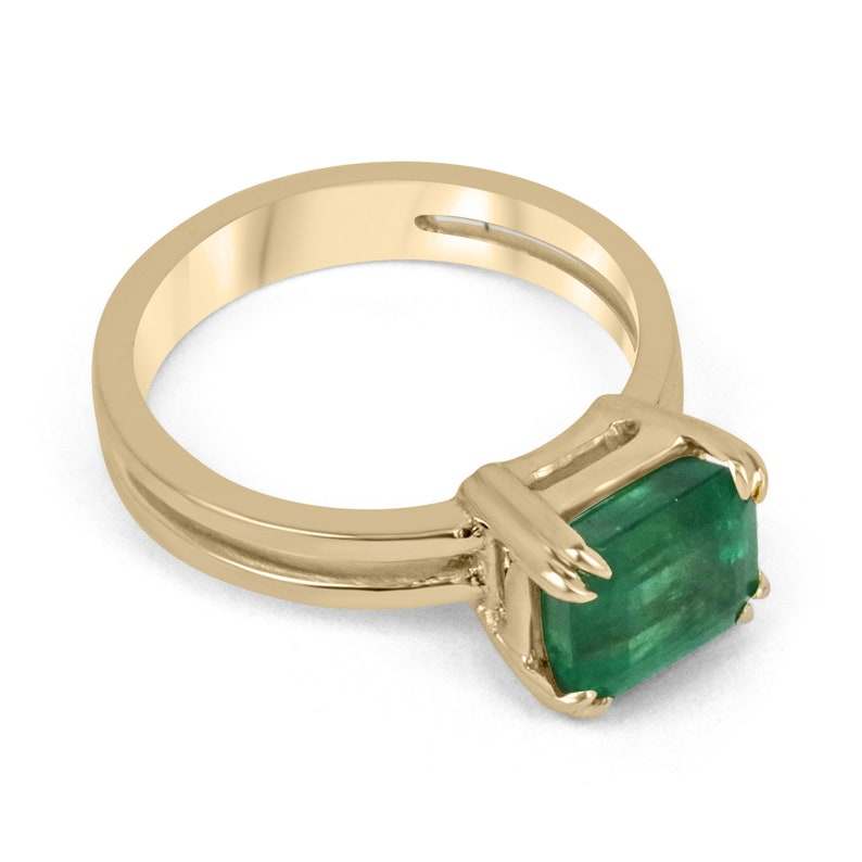 Colombian Emerald ladies ring featuring 2.68ct emerald cut yellowish-green emerald, double claw prong, gold split shank band.
