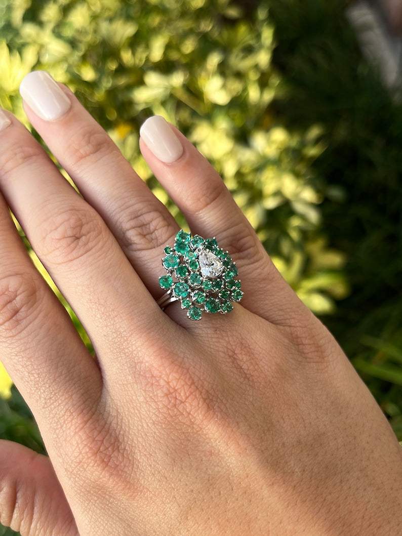 Lady's Colombian Emerald and diamond cluster teardrop statement ring in 14K white gold with 3.38tcw total weight.