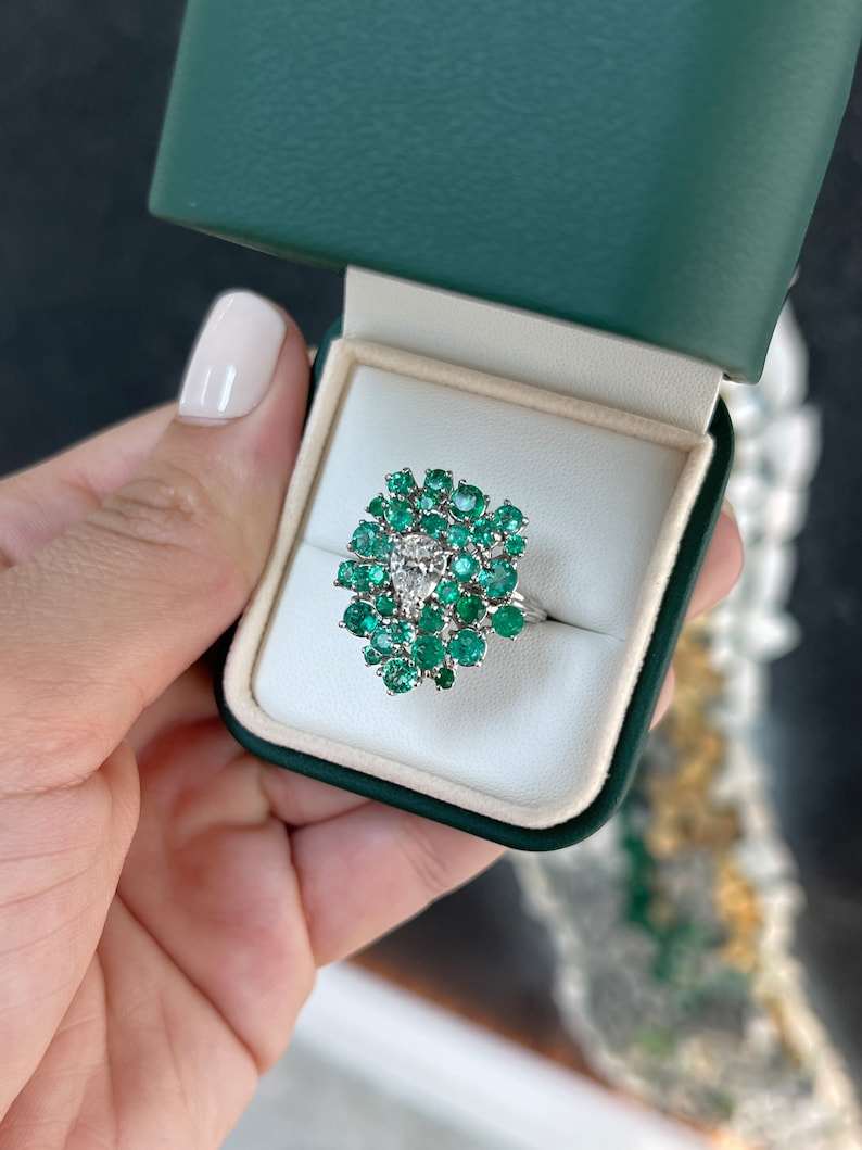 Ladies emerald cluster ring featuring a 3.38tcw teardrop diamond and Colombian emeralds in 14K white gold.