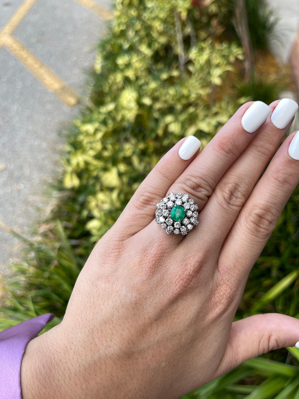 Colombian Emerald ladies cocktail ring with cushion-cut emerald center and diamond accents in 14K white gold.
