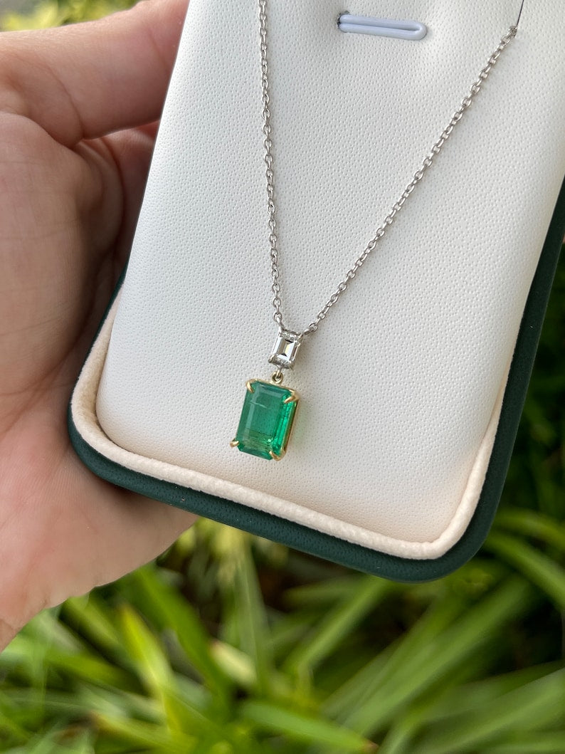 Dark green emerald cut diamond pendant necklace with two-toned gold chain, featuring a 3.13 carat Colombian emerald.