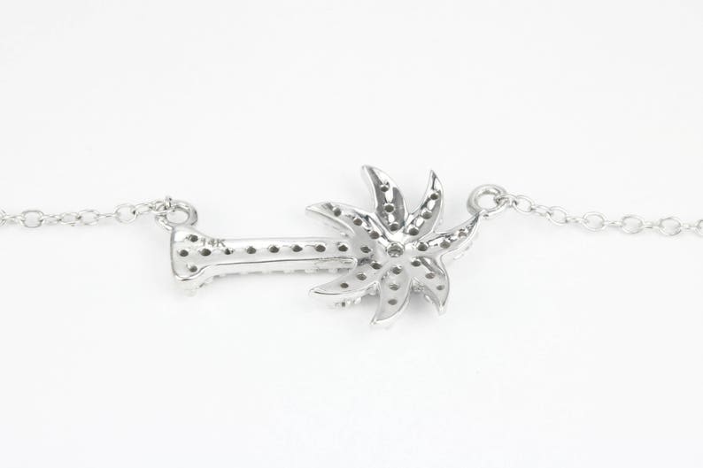 14K gold pendant necklace featuring a 0.25pt natural diamond palm tree design, Colombian Emerald brand jewelry.