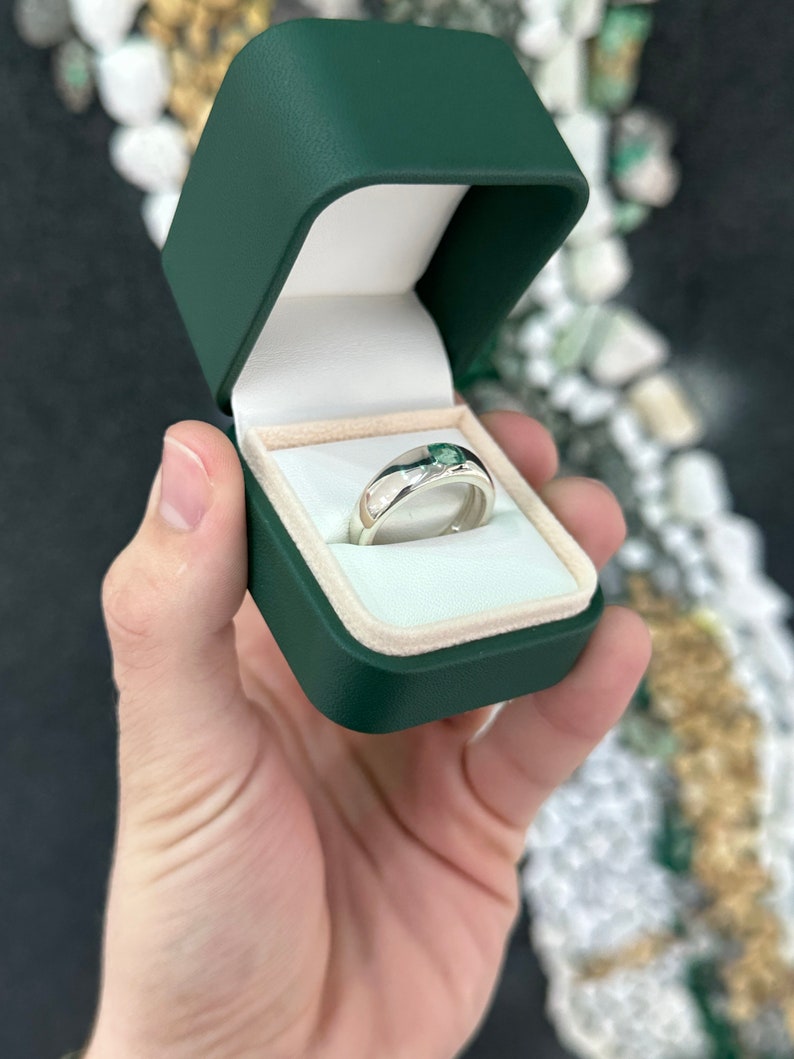 Sterling silver unisex pinky ring featuring a 0.95 carat Asscher cut emerald bezel set solitaire from Colombian Emerald.