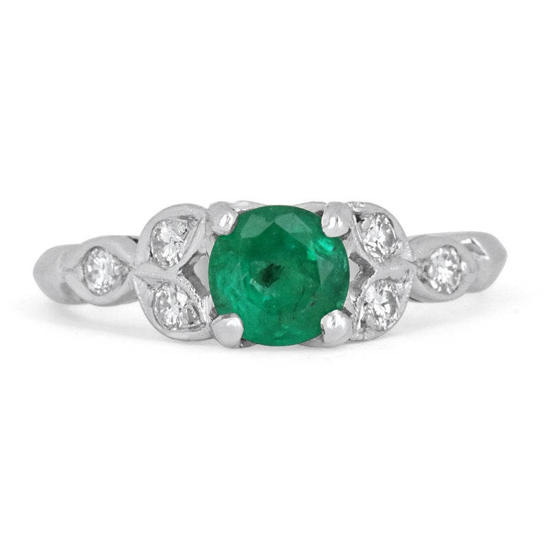 14K gold floral ring with 0.96 carats Zambian emerald and round-cut diamonds, featuring intricate floral design.