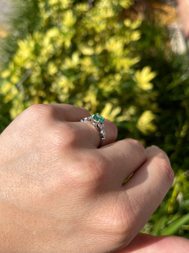 14K gold floral ring featuring a 0.96 carat Zambian emerald and round cut diamonds, Colombian Emerald brand jewelry.