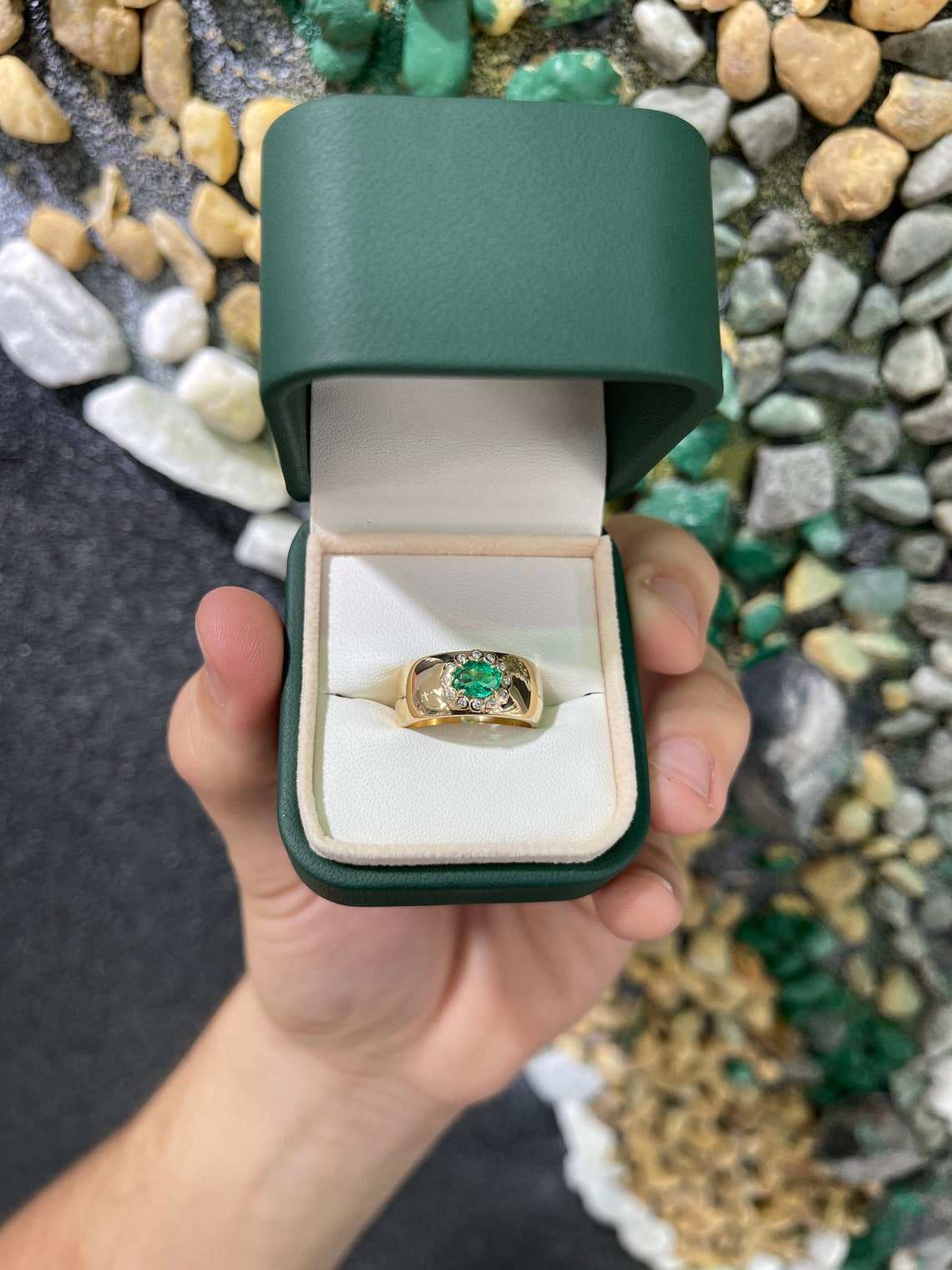 Oval cut Colombian emerald ring with diamond halo accents in 14K gold, showcasing vibrant green emerald and sparkling diamonds.