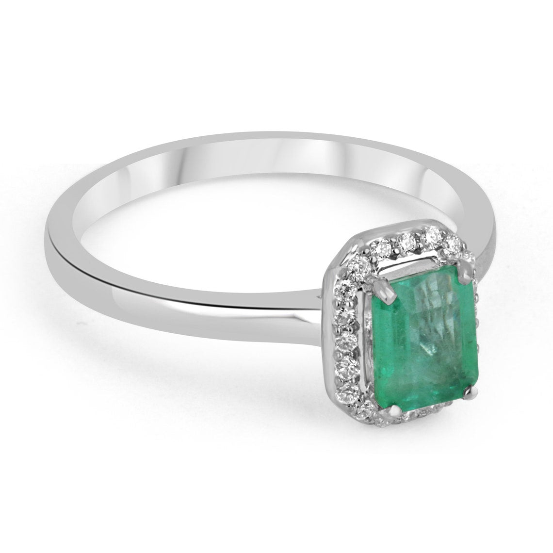 Natural emerald cut engagement ring with diamond halo in 14K gold, featuring a Colombian Emerald brand design.