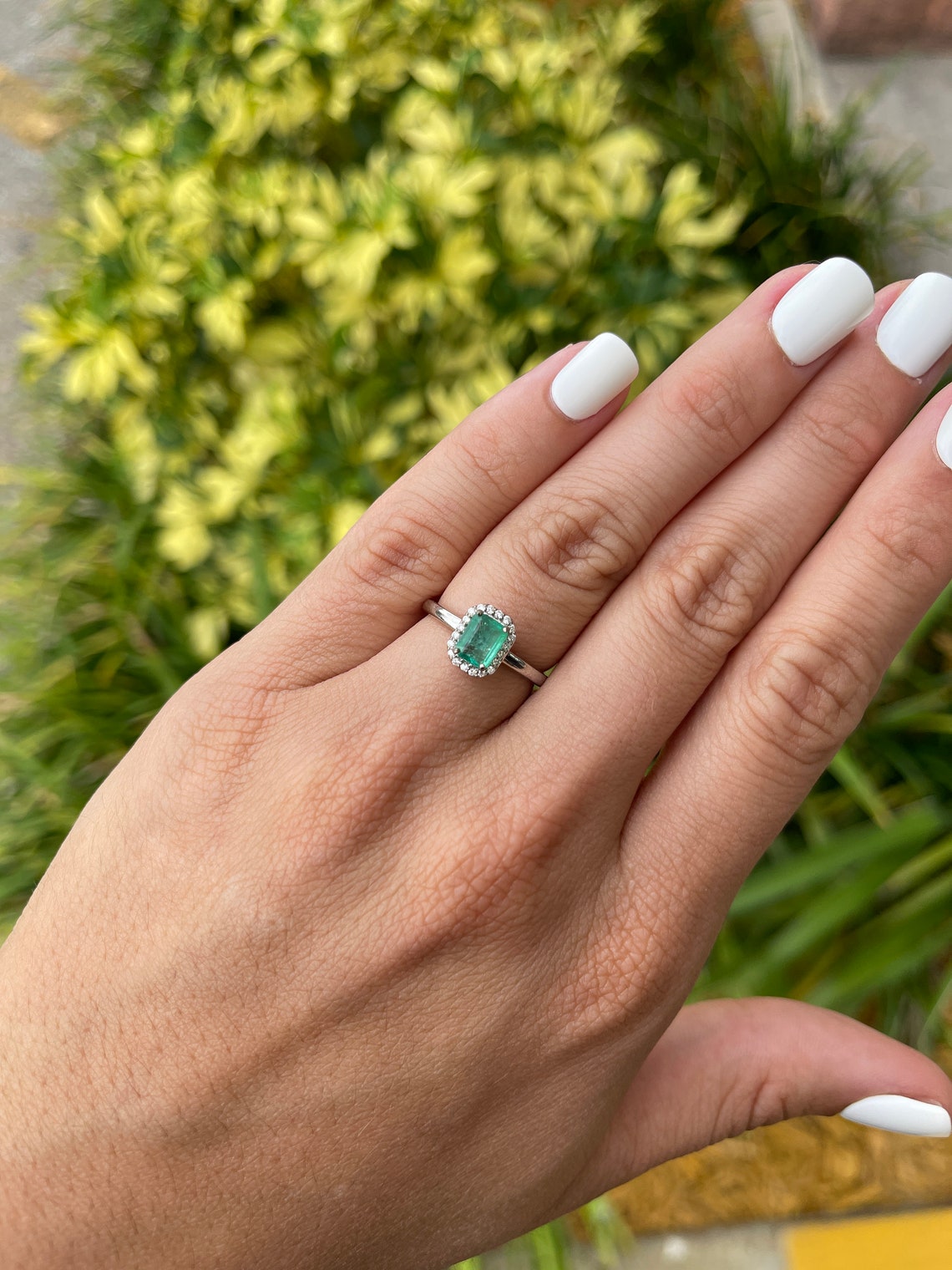 Natural emerald cut engagement ring with diamond halo, 14K gold, from Colombian Emerald, showcasing the elegant jewelry design.