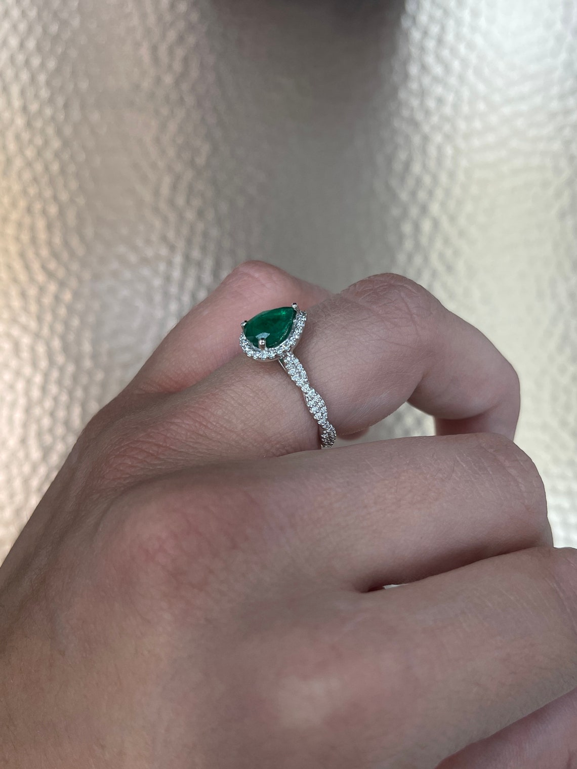 Natural emerald pear-cut engagement ring with diamond halo accents in 14K gold by Colombian Emerald.