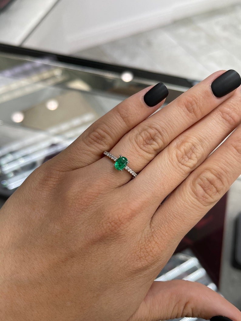 Oval cut natural emerald and diamond engagement ring in 14K white gold with Colombian Emerald branding