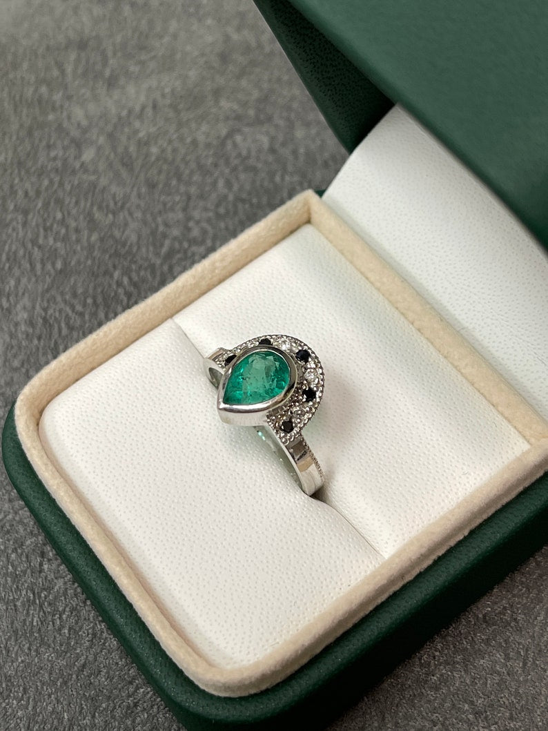 14K emerald pear cut black diamond tiara ring with 1.63tcw, featuring intricate design and Colombian emerald branding.