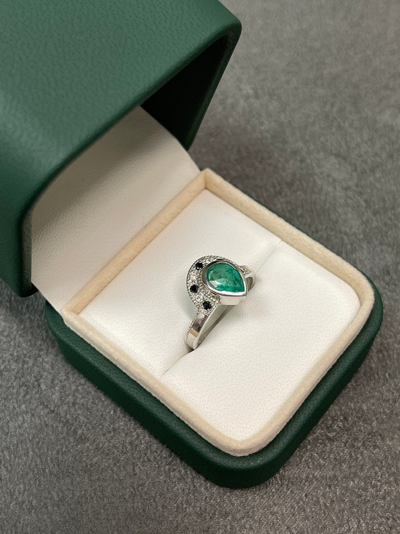 14K yellow gold ring with a large emerald pear cut black diamond centerpiece, featuring a tiara-inspired design.