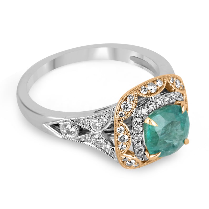 Colombian Emerald engagement ring featuring a 2.14tcw deep ocean green cushion cut emerald with diamond accents in 14K gold