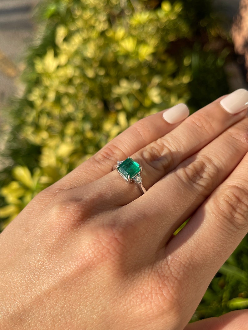 Dark green genuine emerald Asscher cut and diamond 3-stone engagement ring in 14K gold, featuring Colombian Emerald brand.