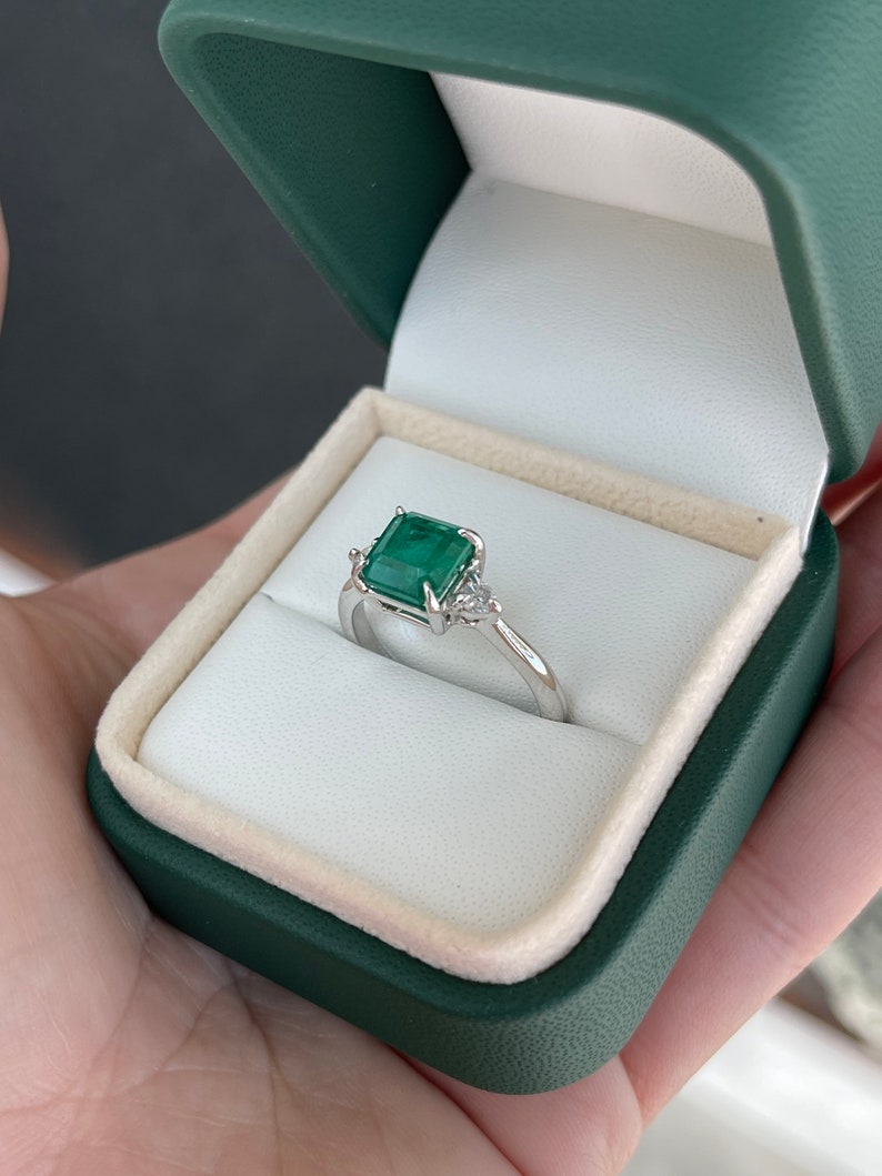Dark green genuine emerald Asscher cut and diamond 3-stone engagement ring in 14K gold, featuring Colombian Emerald branding.