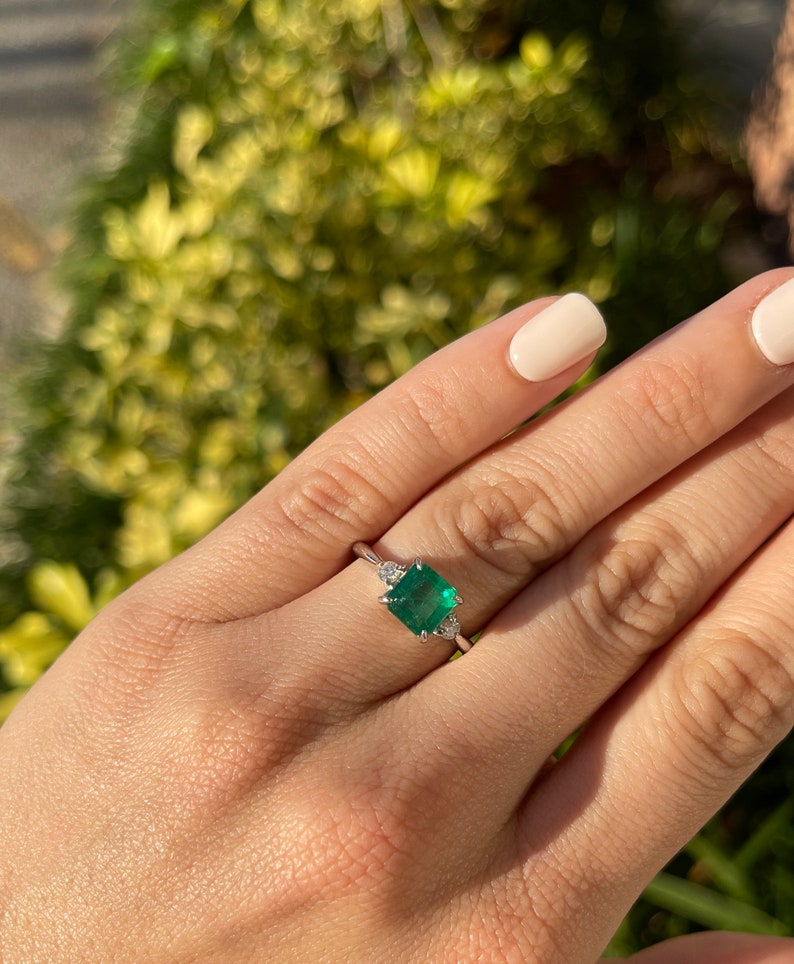 Dark green genuine emerald and diamond 3-stone engagement ring with Asscher cut emerald in 14K gold, by Colombian Emerald.