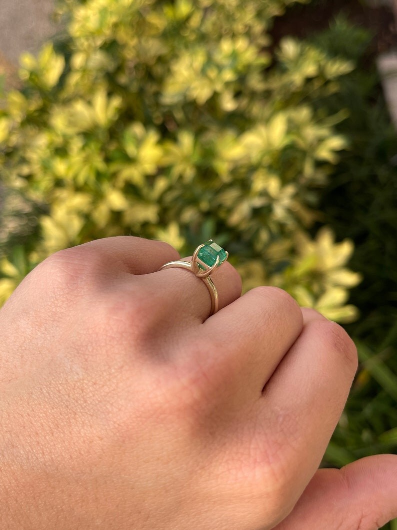 14K gold solitaire engagement ring with a 2.65ct emerald-cut Colombian emerald, classic and elegant jewelry piece.
