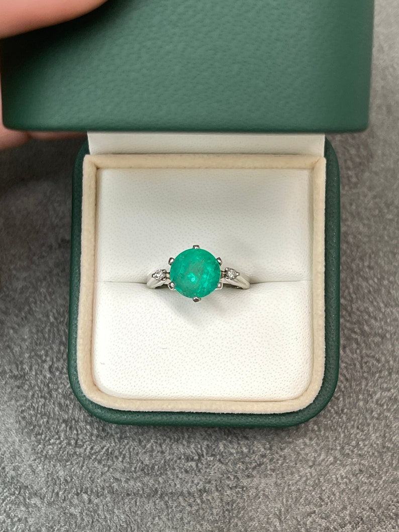 14K gold ring with three round cut Colombian emeralds and diamond accents, featuring a 3.21tcw total weight design.