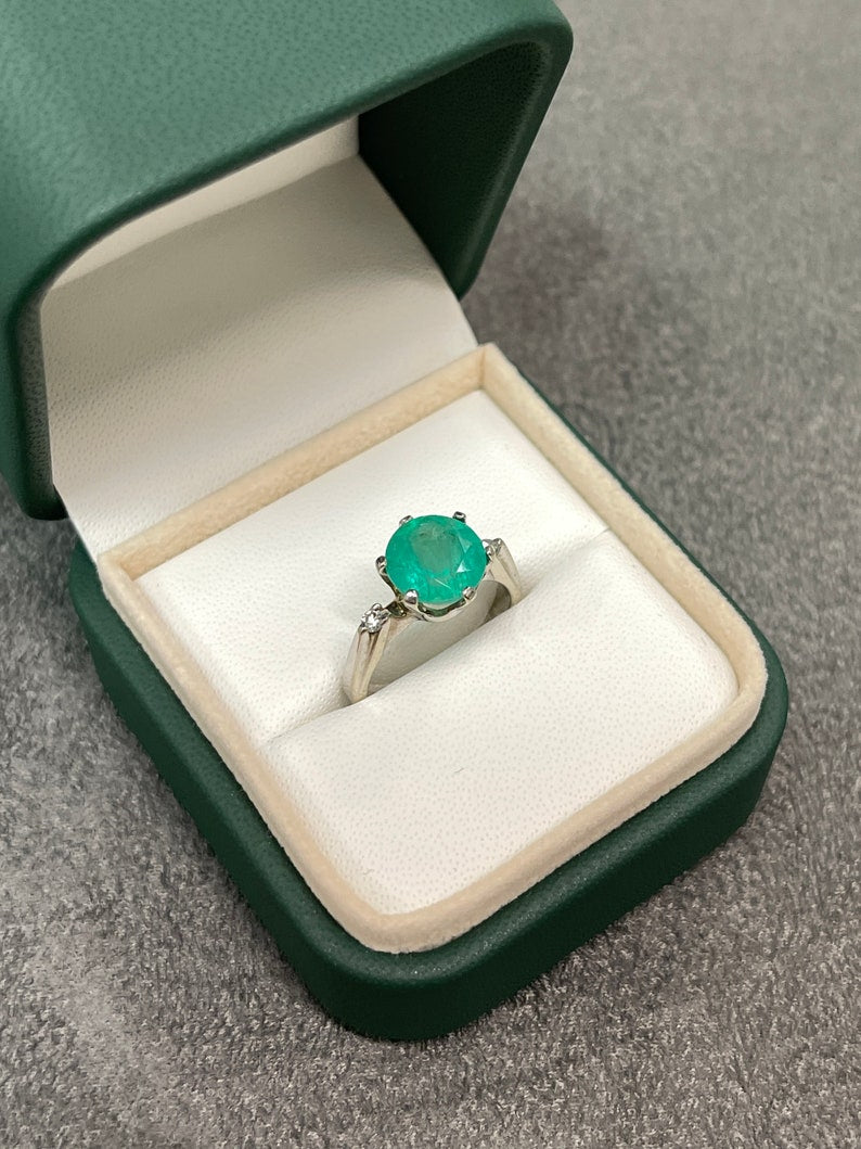 14K gold three-stone ring featuring 3.21tcw Colombian emeralds with round cut and diamond accents in a fine jewelry design