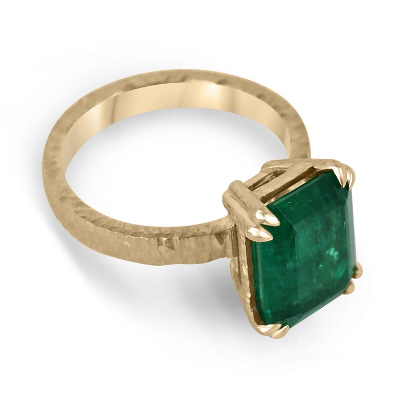 Colombian Emerald 18K matte hammered gold solitaire ring with dark green emerald-cut stone and rustic double claw setting