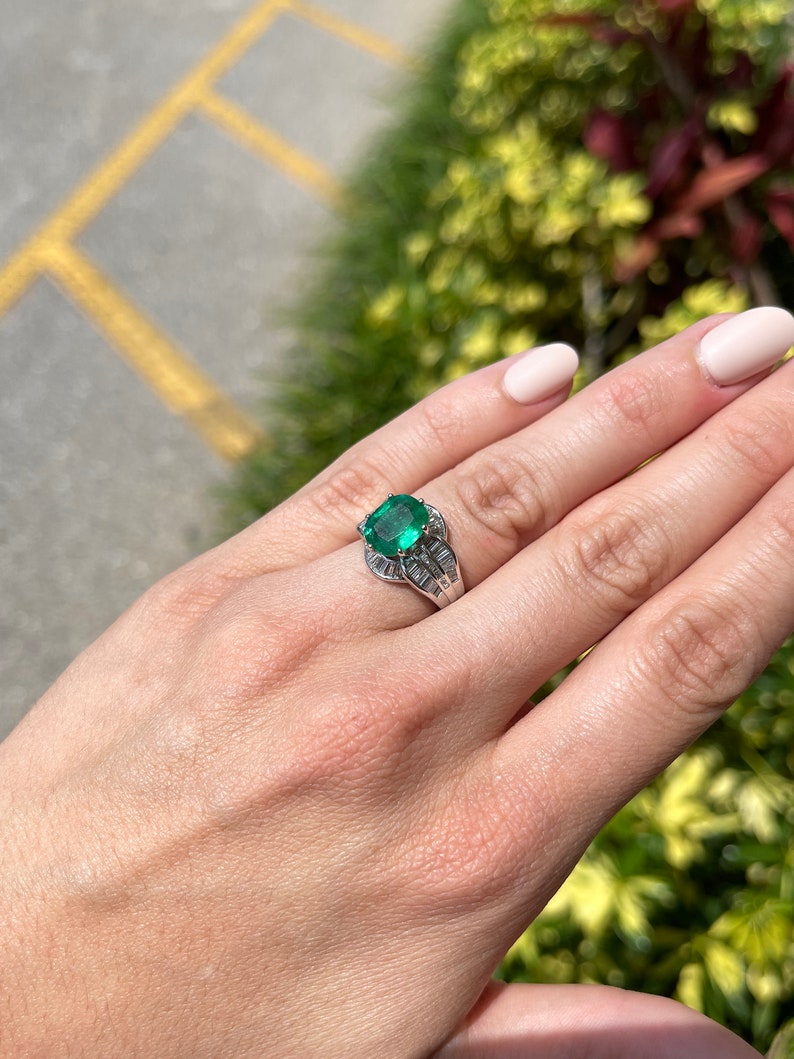 Antique Colombian Emerald and diamond ring with 3.77tcw oval cut emerald set in 18K white gold, detailed craftsmanship.
