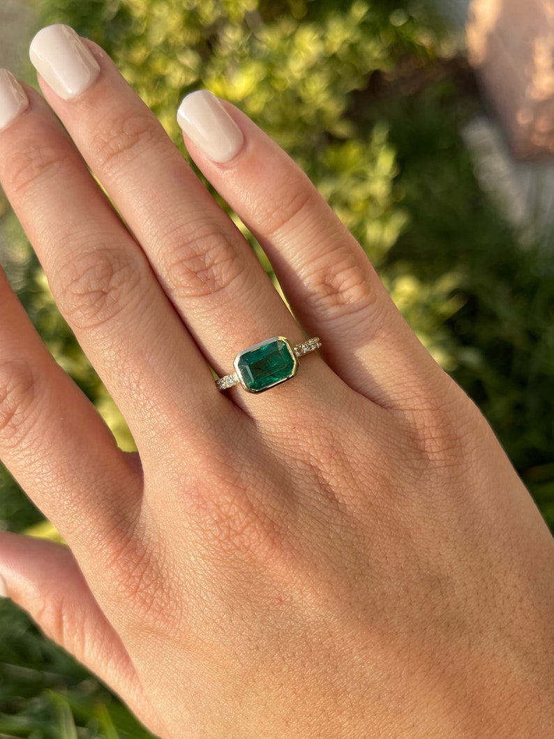 14K gold ring with natural emerald cut emerald and diamond shank, bezel set, from Colombian Emerald, elegant jewelry design.