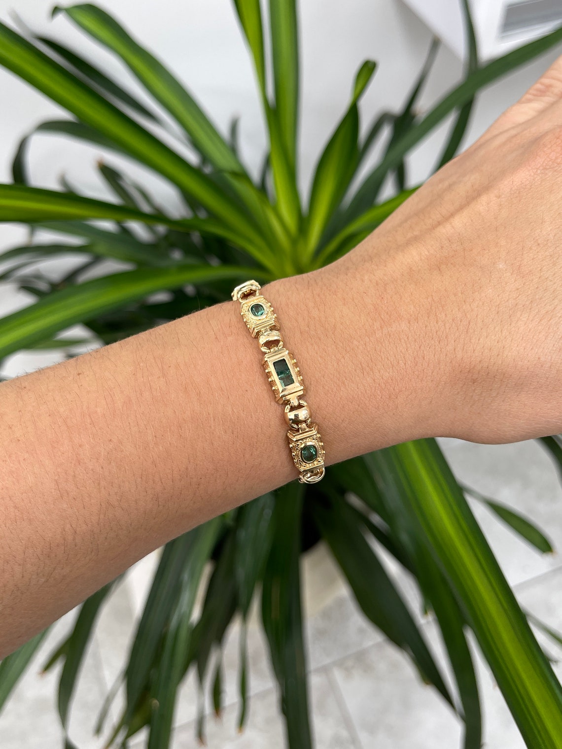 Emerald-Asscher & Oval Cut Gold Bracelet on Hand