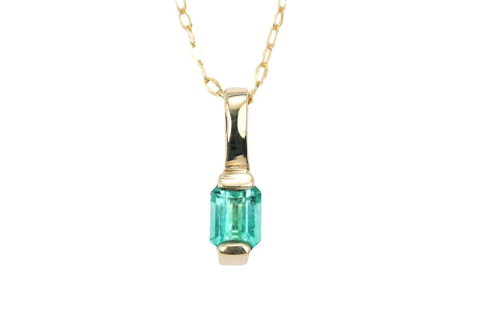 0.65 carat emerald emerald-cut pendant in 14K yellow gold half bezel setting minimalist necklace