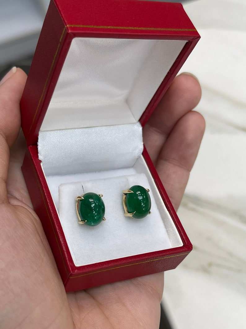 Dark forest green emerald cabochon oval cut earrings in 14K gold from Colombian Emerald, featuring elegant gemstone design.