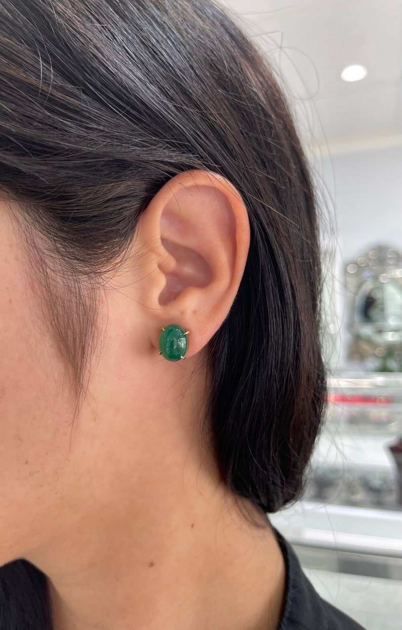 Dark forest green emerald cabochon oval cut earrings in 14K gold from Colombian Emerald, showcasing elegant gemstone jewelry.