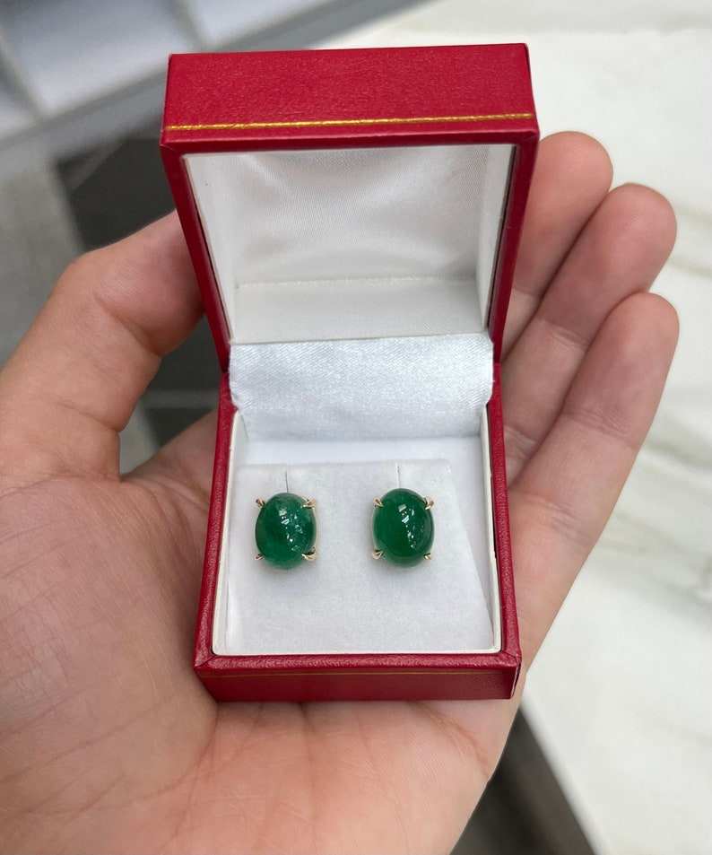 Dark forest green emerald cabochon oval cut earrings in 14K gold from Colombian Emerald, featuring polished, elegant gemstone settings.