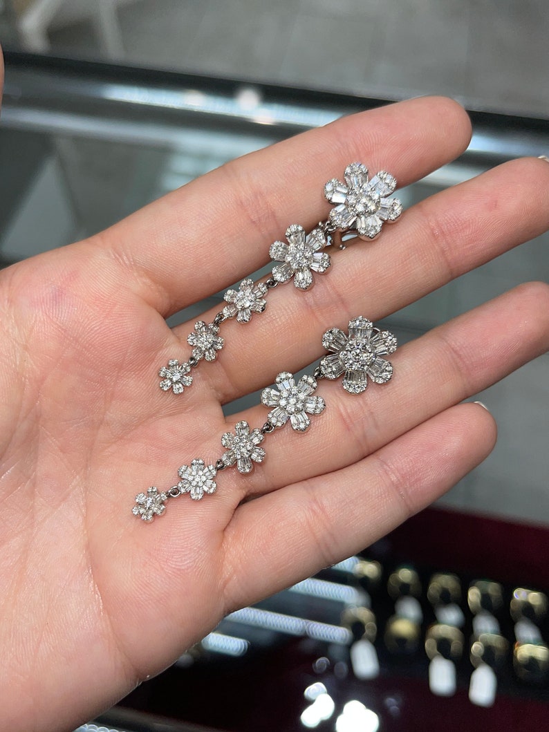 Brilliant Round & Baguette Cut Diamond Chandelier Statement Earrings on Hand