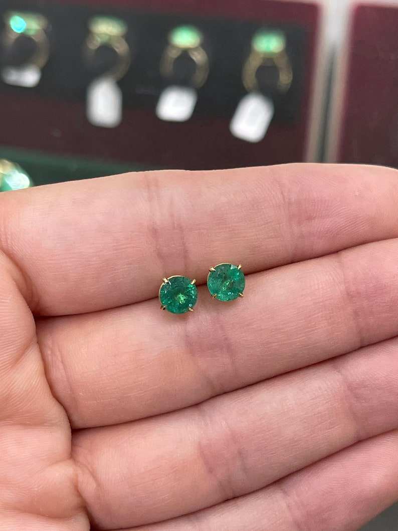 Natural emerald round shape earrings with 2.0 carats total weight in 14K gold, featuring rich dark green Colombian emeralds.