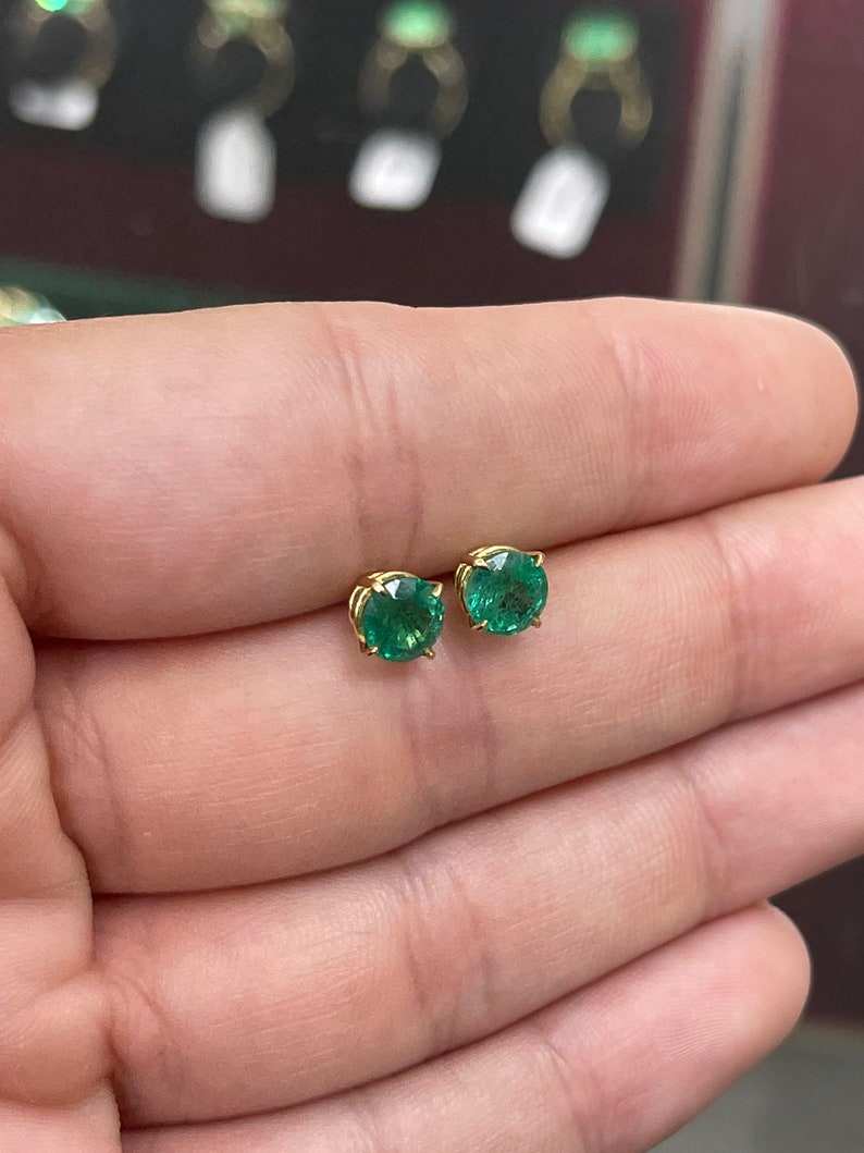 Colombian Emerald 2.0tcw round shape dark green four prong earrings in 14K gold, featuring rich natural emerald gemstones.