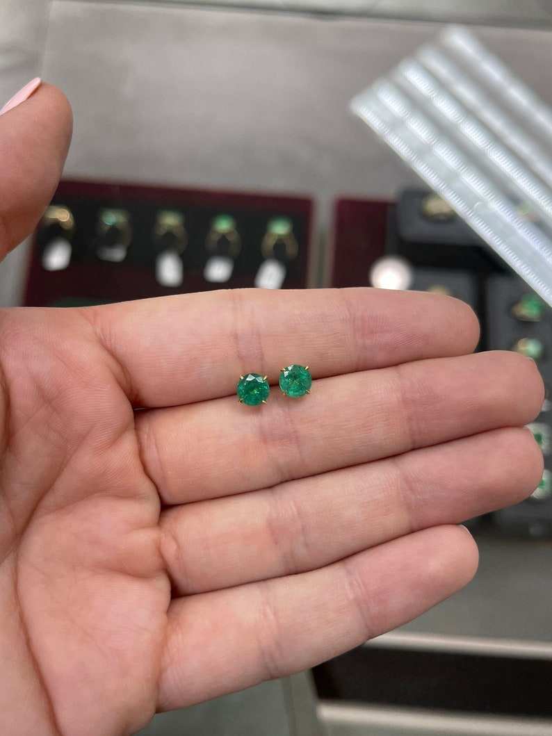 Natural emerald round shape earrings with four prongs, 2.0tcw, set in 14K gold, from Colombian Emerald brand.