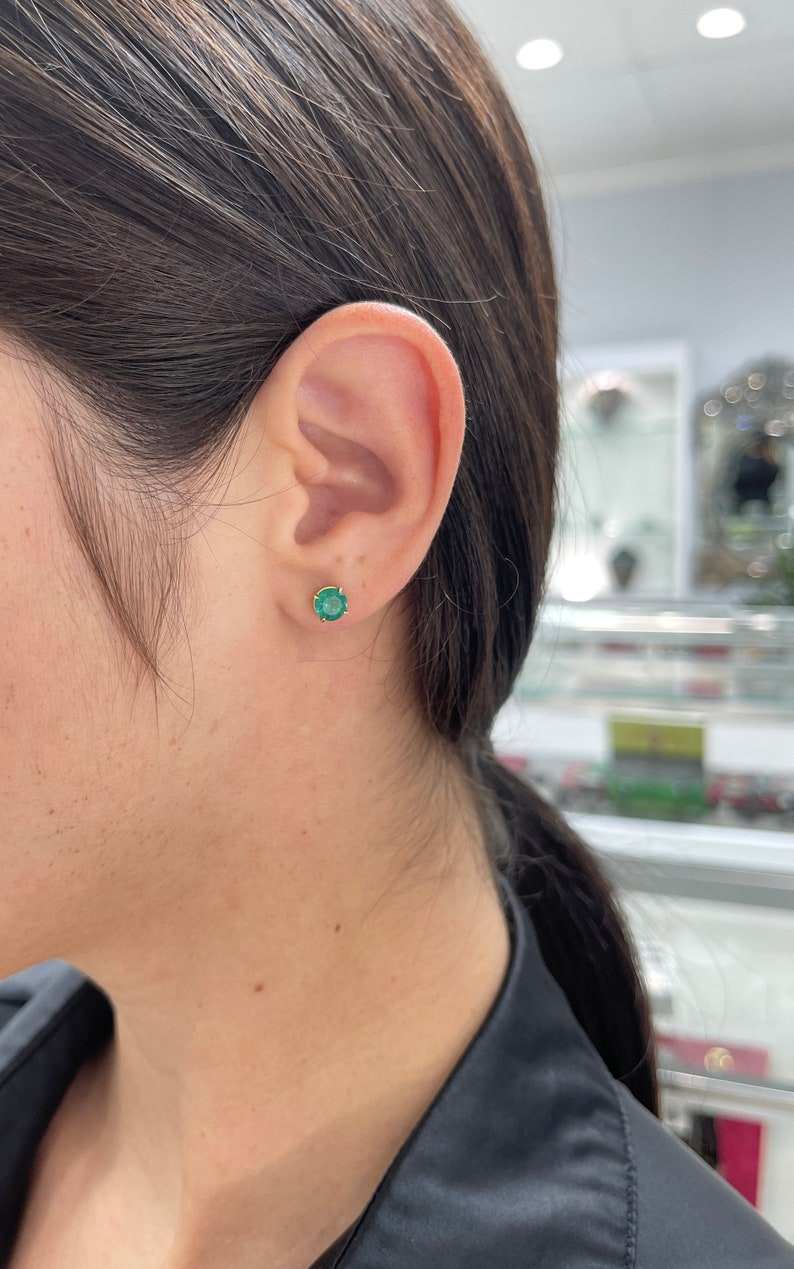 Natural emerald earrings with round cut stones, 2.0 tcw, set in 14K gold with four-prong settings, Colombian Emerald brand.
