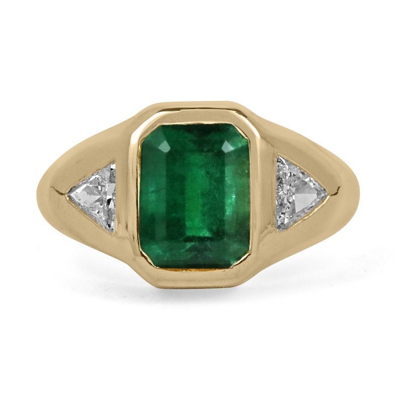 3.24tcw 18K yellow gold ring with emerald cut emerald and trillion cut diamond accents