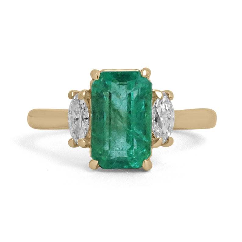 14K yellow gold three-stone engagement ring with medium bluish green emerald center and marquise cut diamonds
