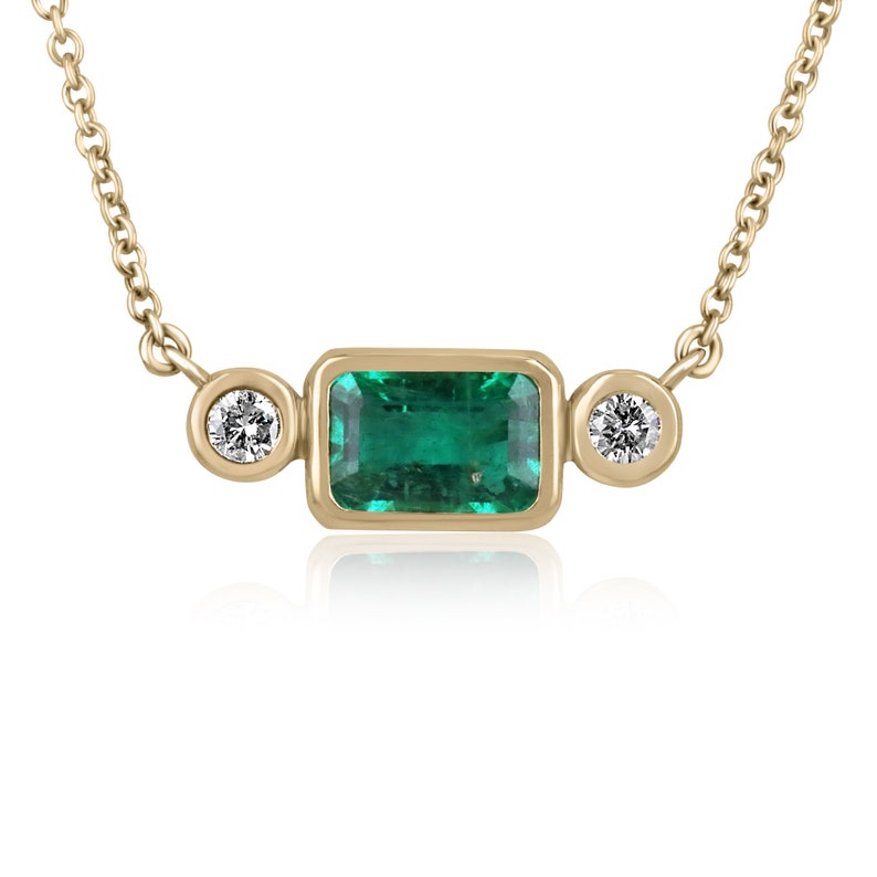 2.77tcw 14K gold necklace with bezel set emerald and round cut diamond side stones